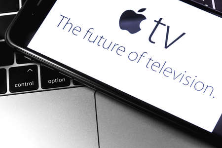 closeup Macbook and iPhone with Apple TV logo on the screen. Apple is a multinational technology company. Moscow, Russia - March 26, 2019のeditorial素材
