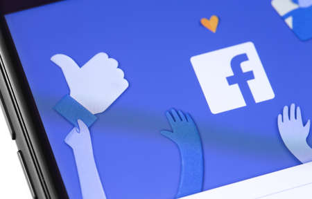 Facebook start page on the screen smartphone. Facebook is largest and most popular social networking...