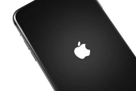 turning on and restart iPhone with Apple logo and on the screen. Apple is a multinational technology company. Moscow, Russia - March 26, 2019のeditorial素材