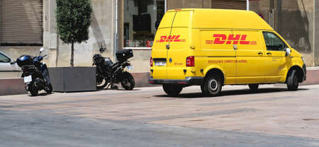 Yellow DHL van in the street. DHL Express is a division of the German worldwide logistics company. Moscow, Russia - May 10, 2019のeditorial素材