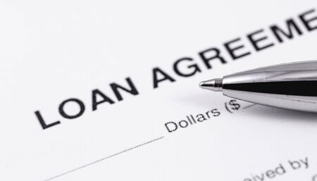 personal loan agreement application form with black pen closeup macroの写真素材