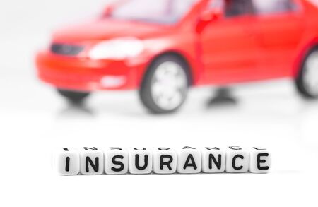 Car insurance. Concept in blocks with word insurance and red car