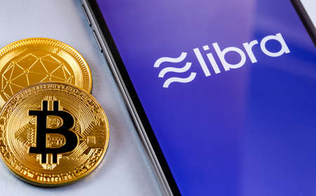 cryptocurrency, bitcoin. Smartphone with  Libra Facebook cryptocurrency logo on the screen. Facebook...