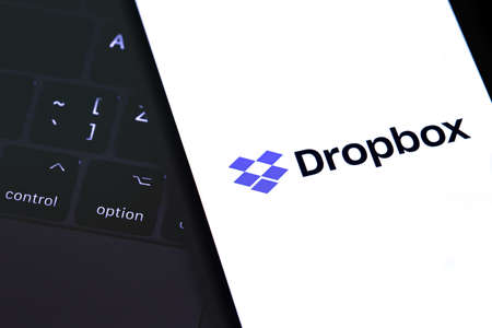 closeup notebook and smartphone with Dropbox logo on the screen. Dropbox is file hosting company Dropbox Inc. Moscow, Russia - June 27, 2019のeditorial素材