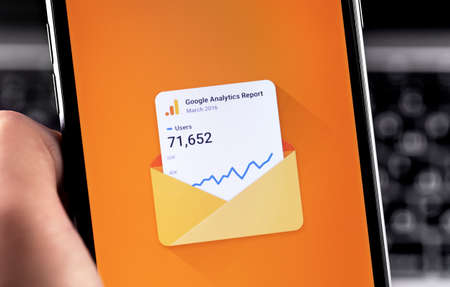 Google Analytics app on the display smartphone closeup. Google Analytics is a free service provided...