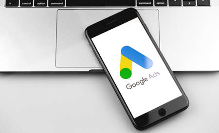 Google Ads (AdWords) logo on the screen iPhone, notebook closeup background. Ads is a service of contextual, basically, search advertising from Google. Moscow, Russia - December 19, 2019のeditorial素材