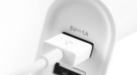 USB charger connector input and USB (5V 1A) ports on the white background closeup, macroの写真素材