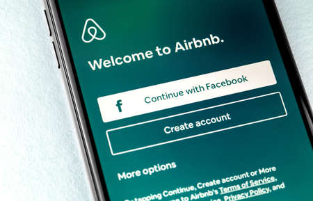 Airbnb app on the screen smartphone. Airbnb is an online marketplace and hospitality service, enabling people to lease or rent short-term lodging. Moscow, Russia - March 19, 2019のeditorial素材