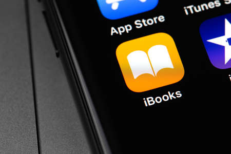 Apple iBooks icon app on the screen iPhone. iBooks is a free app from Apple Inc. for reading e-books. Moscow, Russia - September 15, 2020のeditorial素材