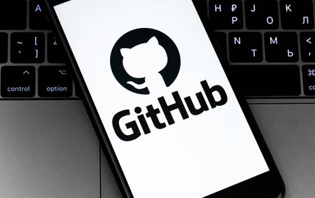 GitHub logo on the screen smartphone with notebook background. GitHub is the largest web service for hosting and developing IT projects. Moscow, Russia - July 12, 2020のeditorial素材