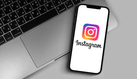 Instagram logo on the screen iPhone with MacBook closeup. Instagram is a photo-sharing app for smartphones. Moscow, Russia - November 18, 2020のeditorial素材