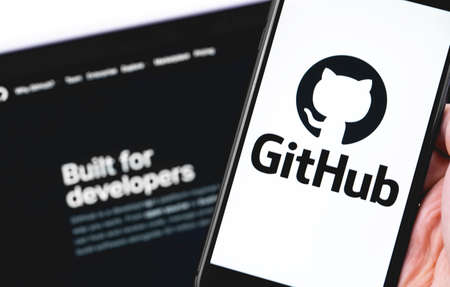 GitHub logo on the screen smartphone and notebook closeup. GitHub is the largest web service for hosting and developing IT projects. Moscow, Russia - July 12, 2020のeditorial素材