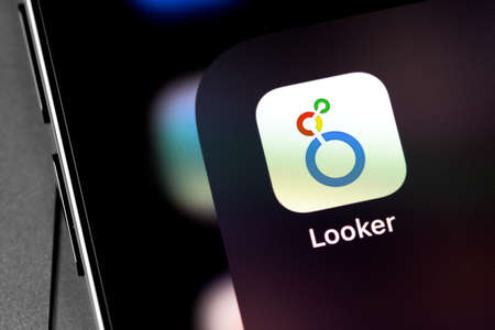 Google Looker app on the screen smartphone. Google Cloud Looker is a business intelligence software...