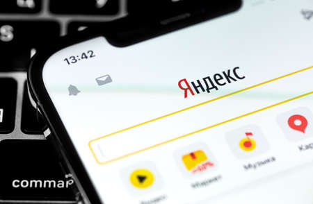 Yandex mobile app on the screen smartphone. Yandex is a Russian multinational company in the information technology industry. Moscow, Russia - November 28, 2020のeditorial素材