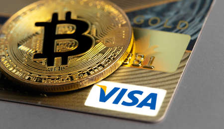 bitcoin cryptocurrency with Visa credit card. Visa - American multinational company providing services of payment operations. Moscow, Russia - August 16, 2020のeditorial素材