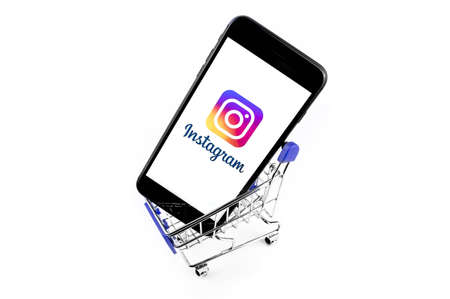 shopping cart with smartphone with Instagram on the screen smartphone. Instagram is a photo-sharing app for smartphones. Moscow, Russia - June 10, 2020のeditorial素材