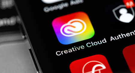 Adobe Creative Cloud mobile app icon on screen smartphone, iPhone closeup. Adobe Creative Cloud - a suite of cross-platform applications from Adobe Systems. Moscow, Russia - February 16, 2021のeditorial素材