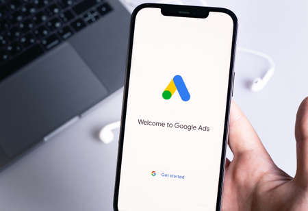 Google Ads (AdWords) logo mobile app on display smartphone iPhone in hand closeup. Google Ads is a service of contextual, basically, search advertising from Google. Moscow, Russia - January 12, 2021のeditorial素材