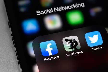 Clubhouse drop in audio chat, Facebook and Twitter on screen smartphone, iPhone. Facebook is largest and most popular social networking site in the world. Moscow, Russia - January 16, 2021のeditorial素材