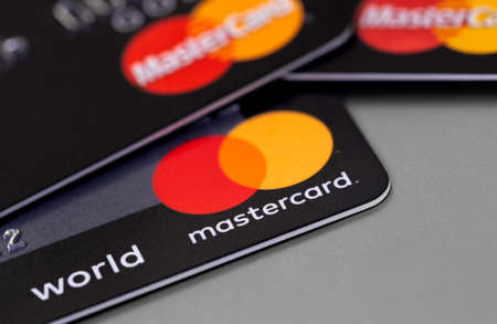 MasterCard plastic electronic, cards on gray background closeup. Master Card is an international payment system. Moscow, Russia - January 18, 2021のeditorial素材
