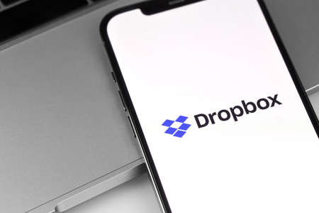 Dropbox logo mobile app on screen smartphone iPhone. Dropbox is file hosting company Dropbox Inc. Moscow, Russia - April 14, 2021のeditorial素材