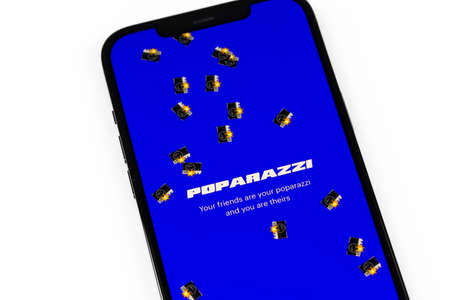 Poparazzi app on screen smartphone, iPhone on white background. Poparazzi is a new social network. Moscow, Russia - May 28, 2021のeditorial素材