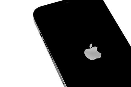 turning on and restart new iPhone with Apple logo and on the screen. Apple is a multinational technology company. Moscow, Russia - January 14, 2021のeditorial素材