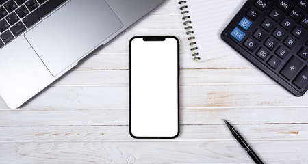 top view mockup of laptop and smartphone iPhone with empty screen on wooden desktop, workplace background. Moscow, Russia - January 23, 2021のeditorial素材