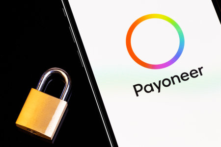 Payoneer mobile app on screen smartphone iPhone with lock closeup. Payoneer - payment system....