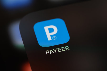 Payeer mobile app on the screen smartphone iPhone. Payeer is a web wallet designed to work with...