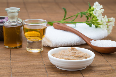 mask white bowl, essential oil,  salt spoon and towel, flower background for health spaの写真素材