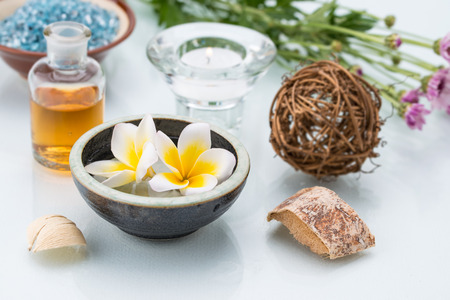 Spa concept with Floating Flowers, wicker, essential oil, Candle and woodの写真素材