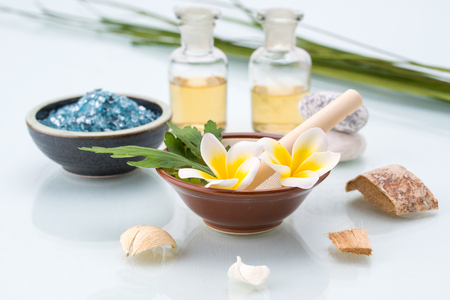 organic Spa concept with Mortar and Pestle, Flowers, leaf, essential oil, and saltの写真素材