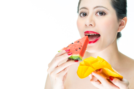 fashion woman eating Tropical fruit, mango, health, makeup, watermelon, biteの写真素材