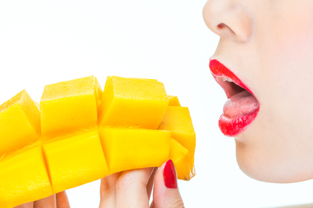 woman eating mango,  healthy, lipstick, desire, bite, nailの写真素材