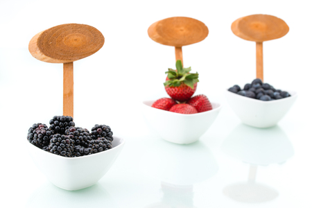 fresh blueberries, Blackberry, strawberry with signboard in bowlsの写真素材