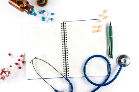 capsules and bottle with notebook and pen and stethoscope, prescription healthcare and medicineの写真素材