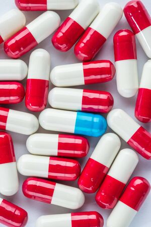 blue capsules and red capsules, illness medication cure pharmaceutical close upの写真素材