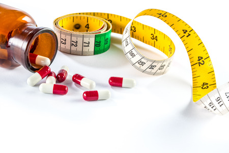 Measuring tape with capsule,  Dieting by medicine lose weightの写真素材