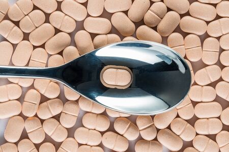 medicine pill over silver spoon, Healthcare and Medicine medication close upの写真素材
