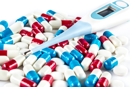 thermometer with pills and Capsule, Fever headache flu unwellの写真素材
