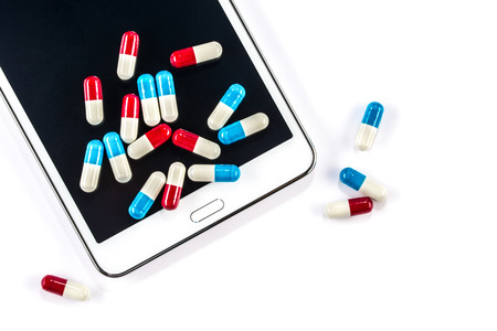 Tablet and pills, Capsule on Touch Screen Mobile Phoneの写真素材