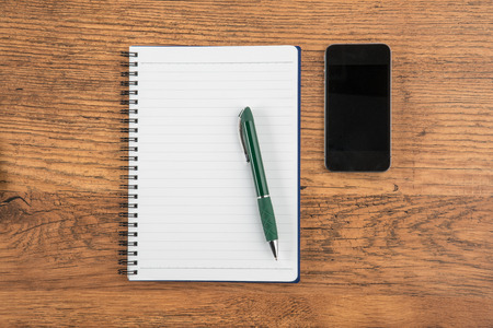 notebook and pen with Smartphone on the desk, meetingの写真素材