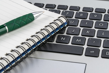 notebook and pen on the laptop keyboard, meeting, close up