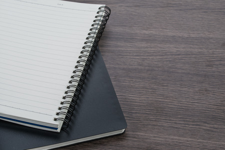 black and white notebook stack on the wood background, stationery