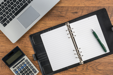 notebook and pen with calculator on the desk finance planの写真素材