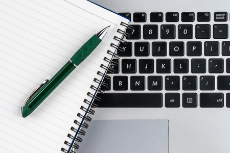 notebook and pen on the laptop keyboard, meeting, close up