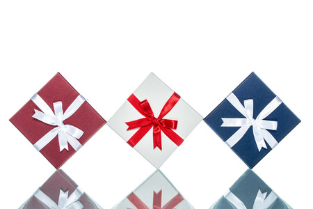 luxury color gift box for holiday event with beautiful silk wrap on white background isolatedの写真素材