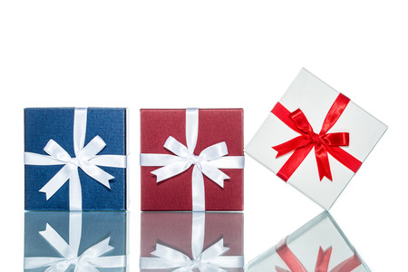 luxury color gift box for holiday event with beautiful silk wrap on white background isolatedの写真素材
