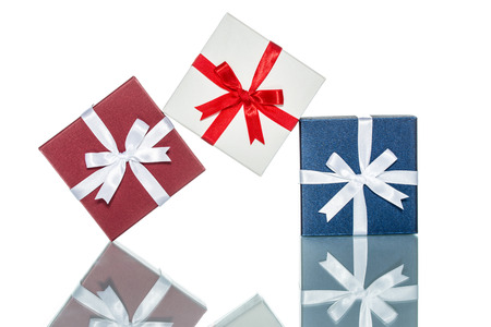 luxury color gift box for holiday event with beautiful silk wrap on white background isolatedの写真素材
